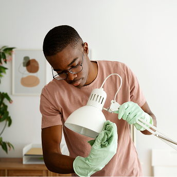 PABCLEAN team member cleaning lamp